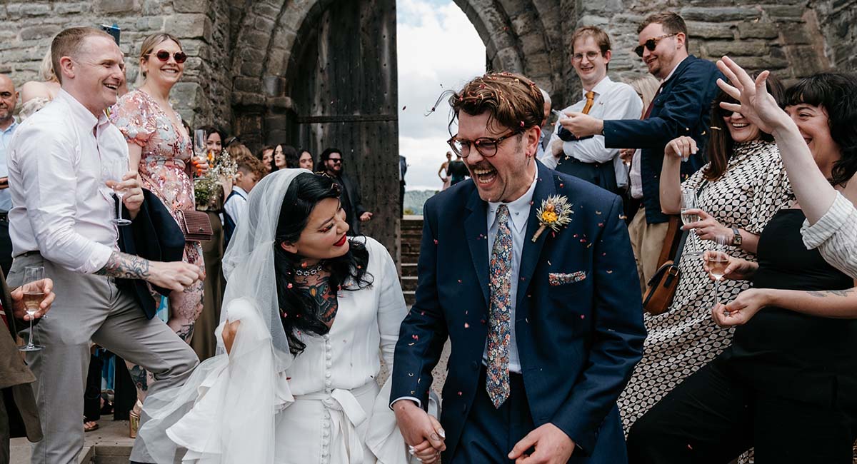 Bride and groom on the steps of Hay Castle